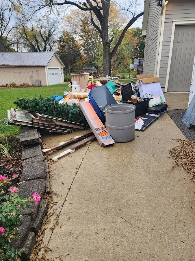 Dumpster being loaded with debris for 12 Yard Dumpster Rental in Colonial Beach